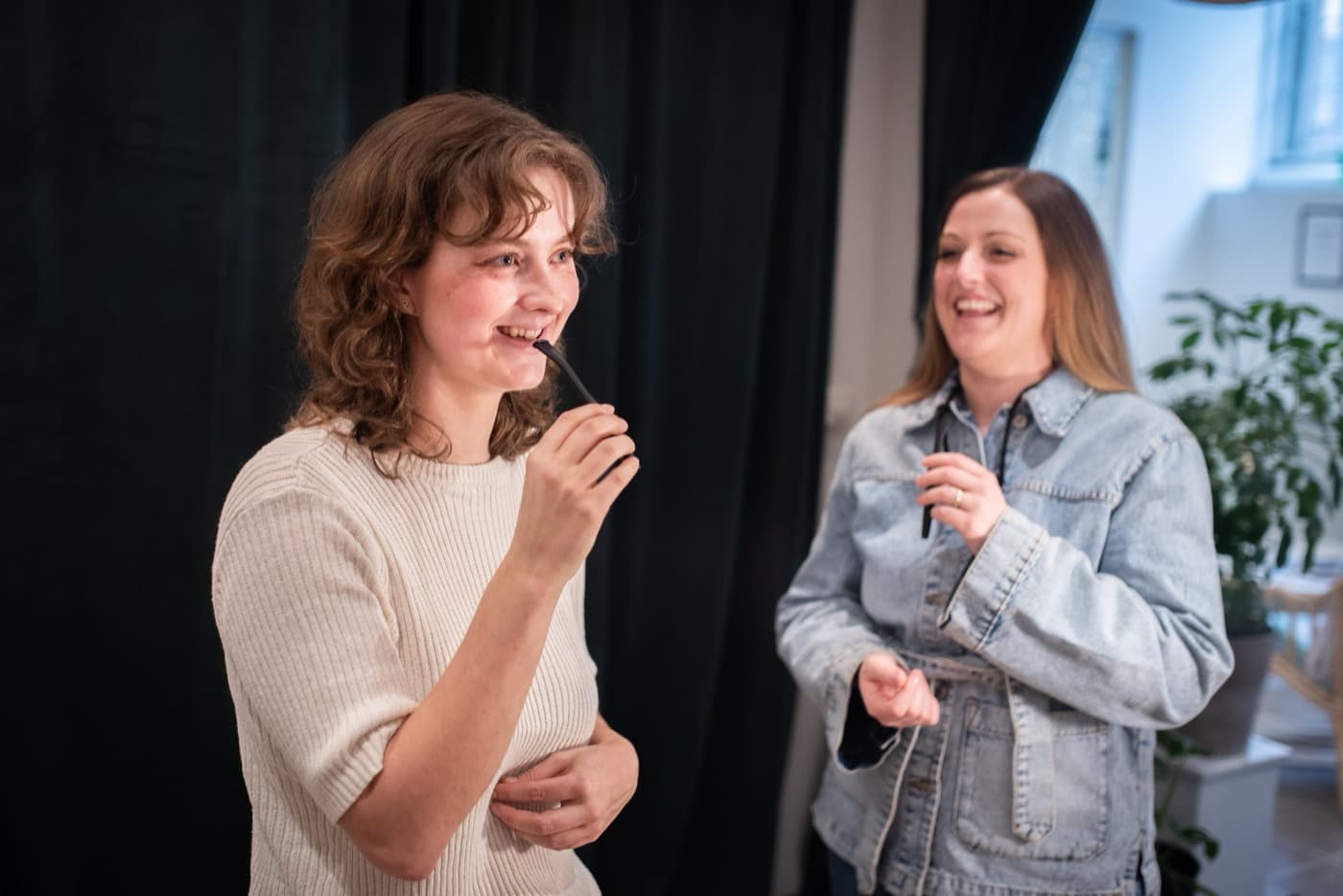 Two singers warming up by humming through their VoicePipes
